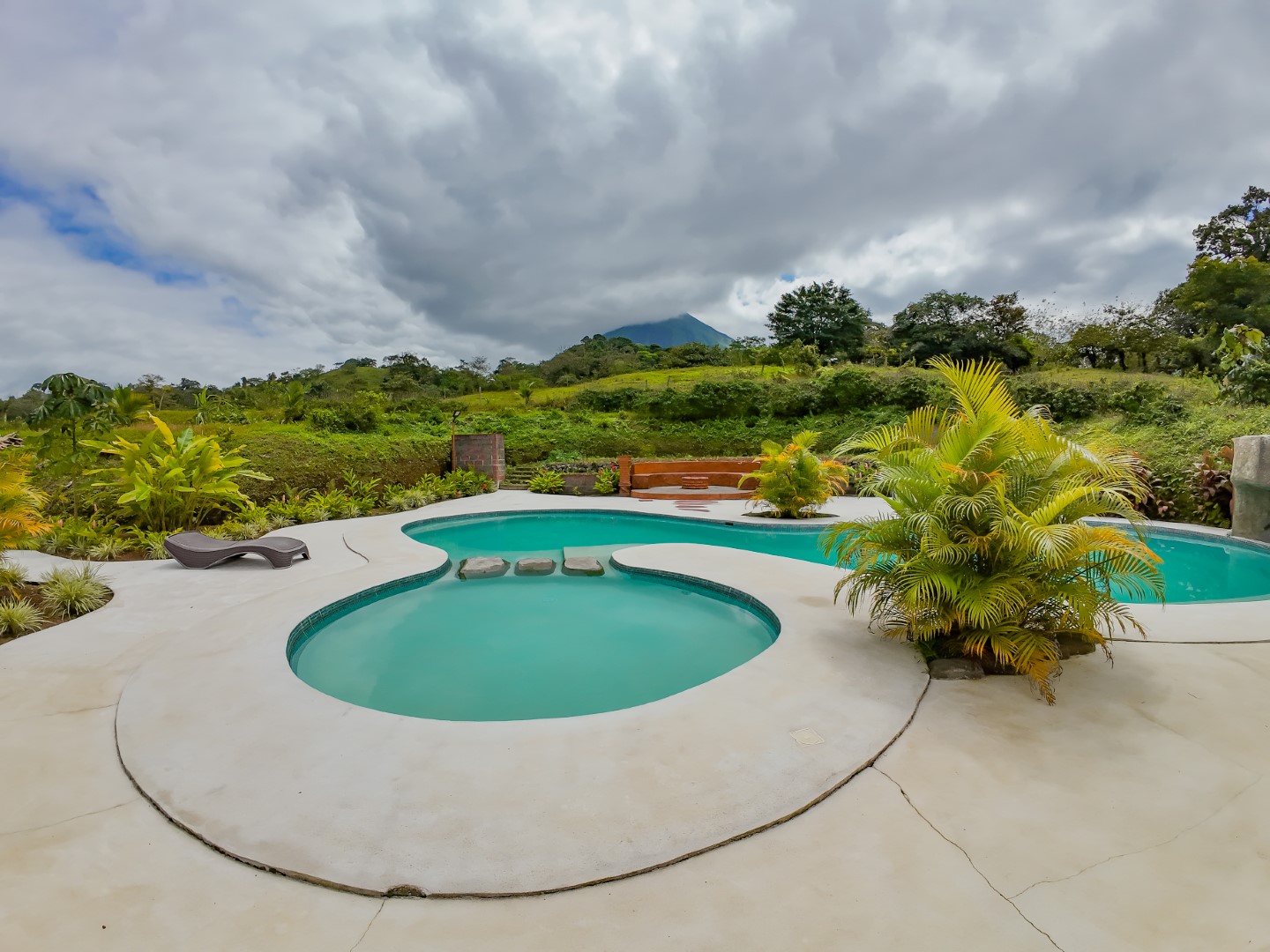 Swimming pool with Arenal Volcano view at sunset